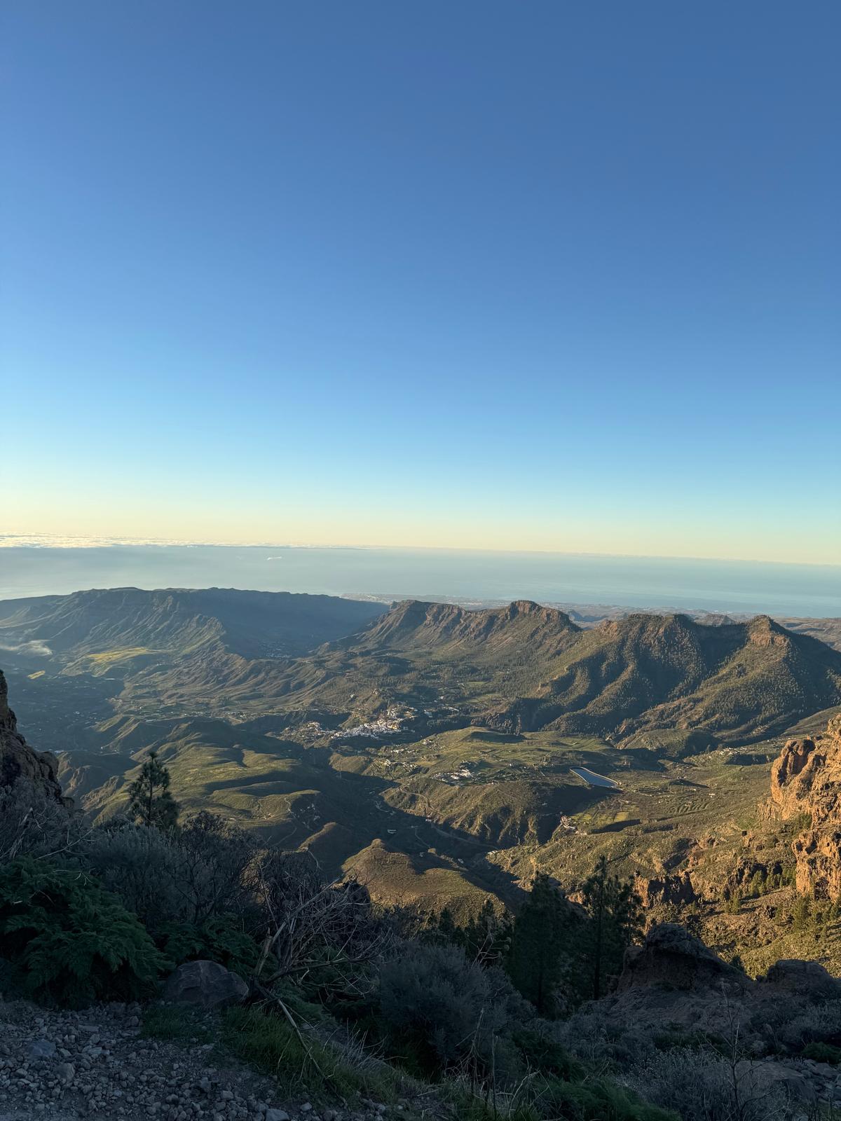 Panoramic view from the mountain road looking down across Gran Canaria's interior with villages and terraced hillsides