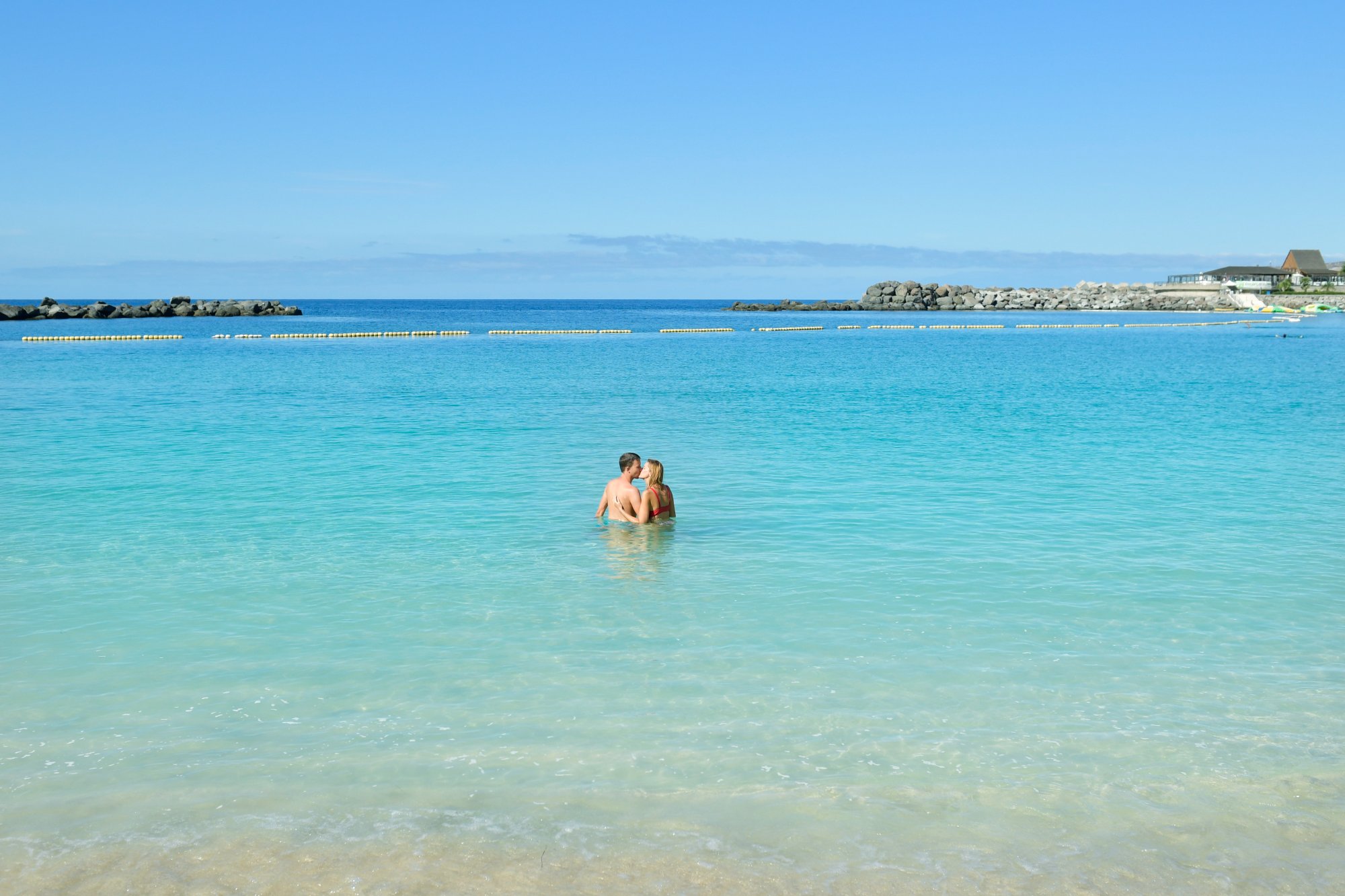 Crystal-clear turquoise water at the sheltered Amadores beach in Gran Canaria