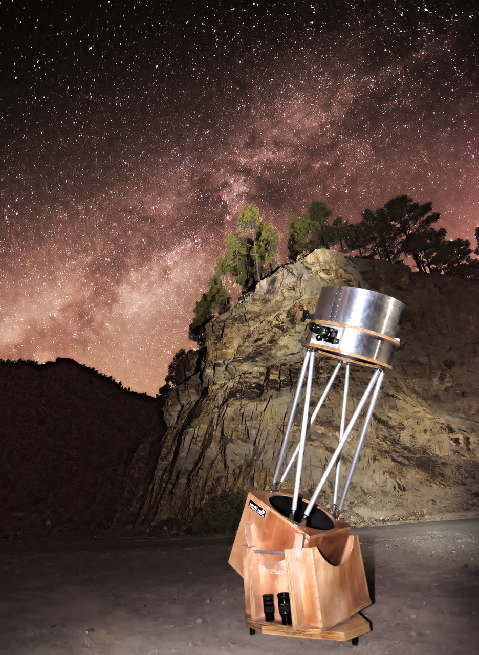 Telescope under the Milky Way during a family stargazing experience